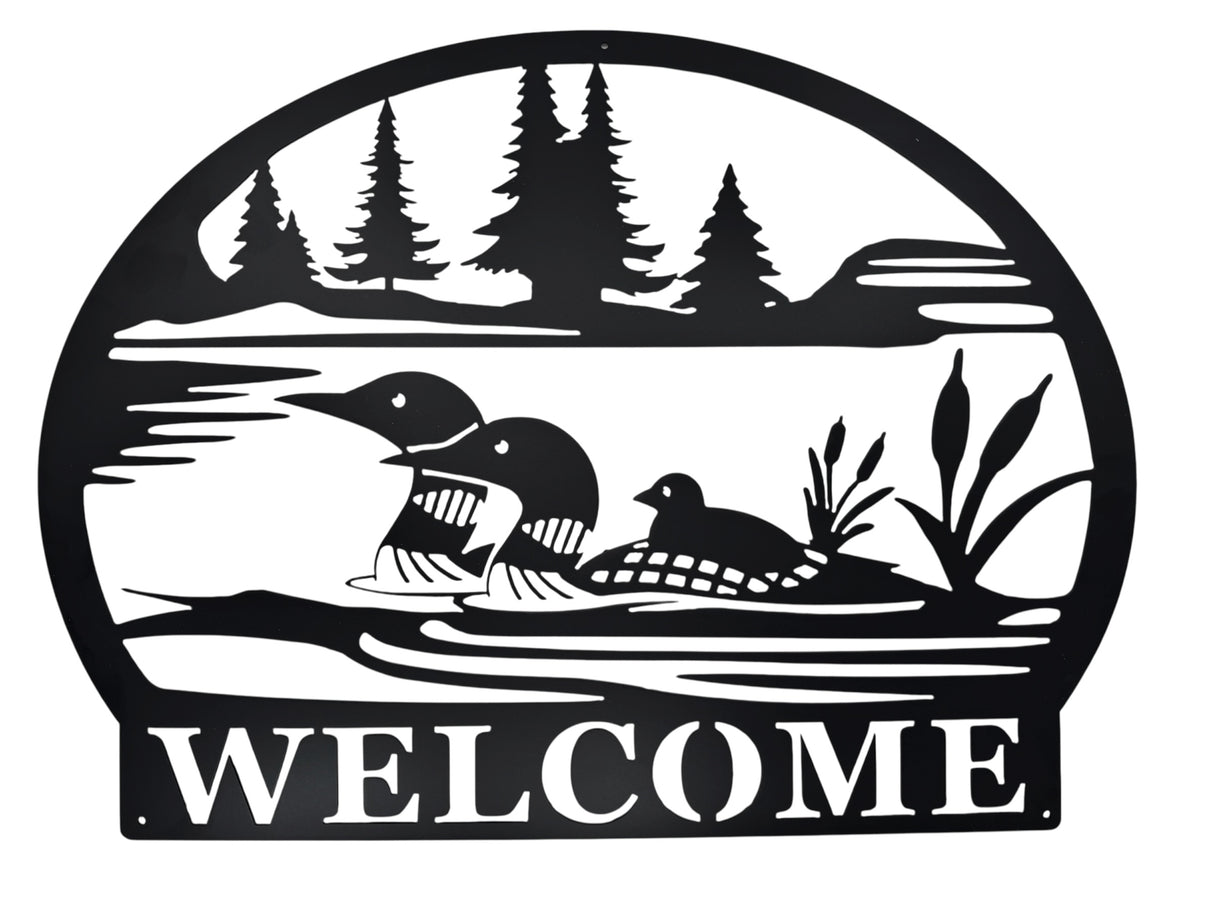 Welcome Loons Wall Decor in matte black metal (23 × 17) features three loons on a lake with trees and cattails, and WELCOME at the bottom—an ideal piece of Scandinavian-inspired art for your home.