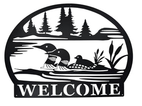 Welcome Loons Wall Decor in matte black metal (23 × 17) features three loons on a lake with trees and cattails, and WELCOME at the bottom—an ideal piece of Scandinavian-inspired art for your home.