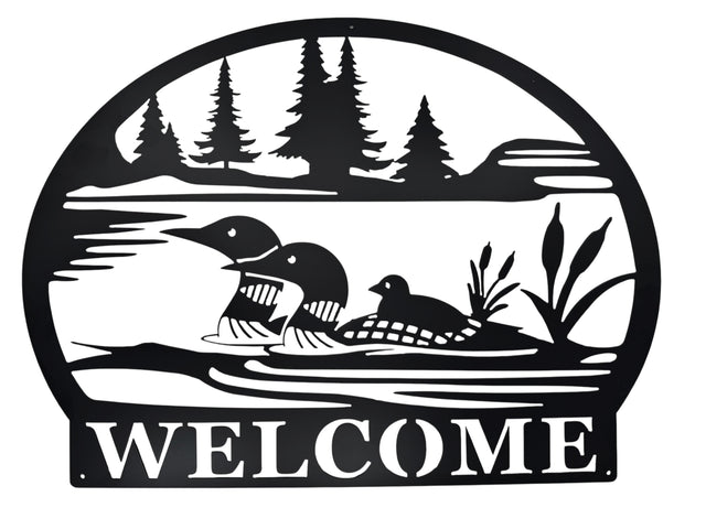 Welcome Loons Wall Decor in matte black metal (23 × 17) features three loons on a lake with trees and cattails, and WELCOME at the bottom—an ideal piece of Scandinavian-inspired art for your home.