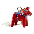 The Red Dala Horse Necklace features a 2cm handcrafted pendant inspired by Swedish Folk Art, painted in blue, yellow, and white, on a 19 sterling silver chain.