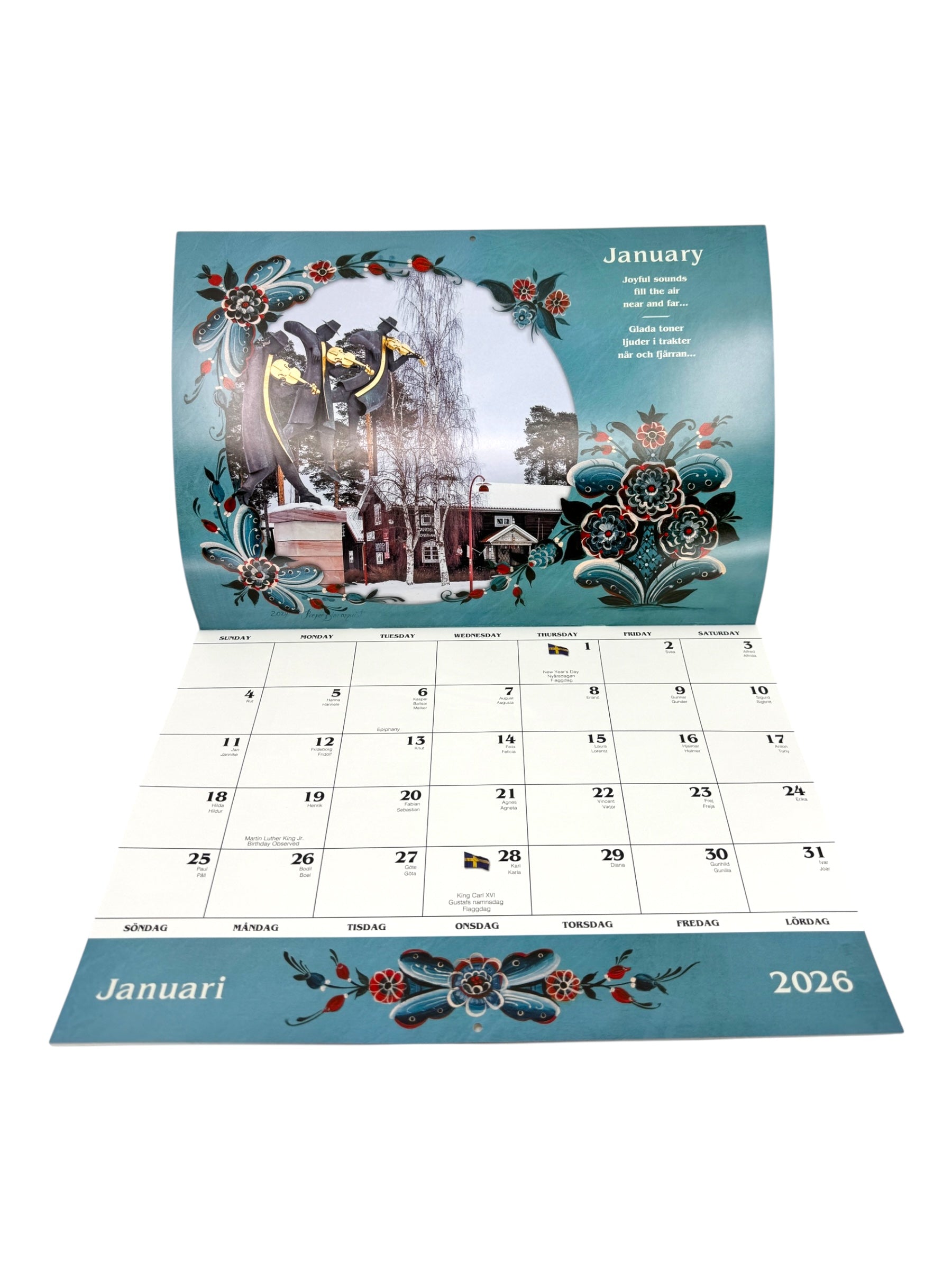 Calendar: Sweden 2025 Wall Calendar – Visions & Verse of a Land and Its People, open to January 2026, displays Nordic folk art and a winter scene with dates in English and Swedish.