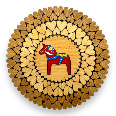 A 6 red Swedish Dala Horse trivet features a circular pattern of laser-cut wooden hearts, handcrafted in Estonia.