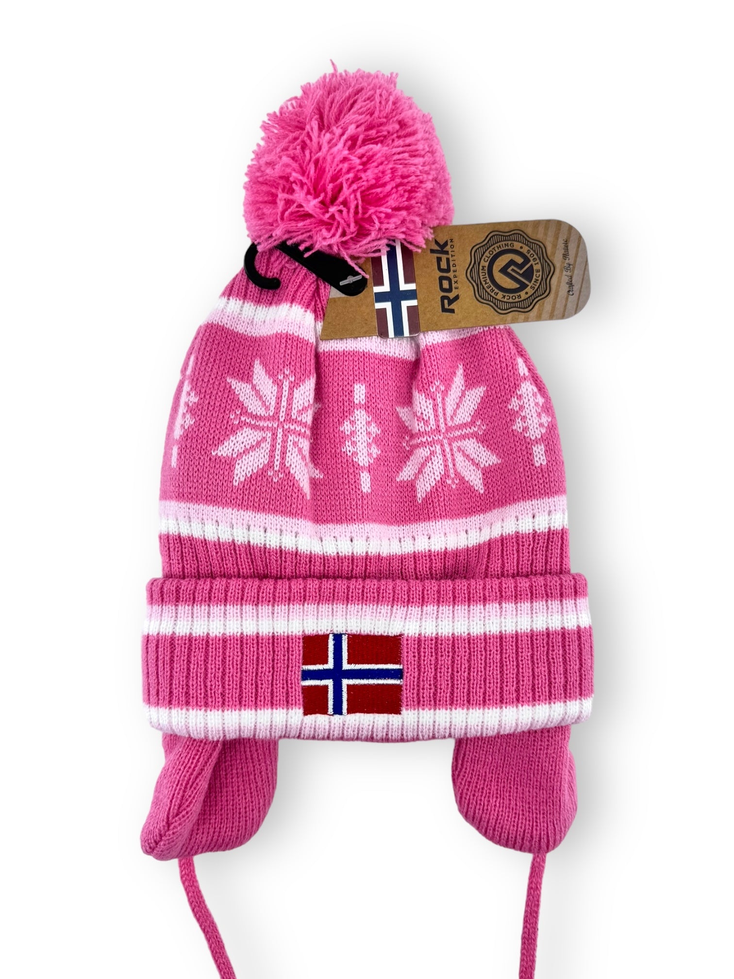 Child's acrylic hat in pink from the Rock Expedition collection, designed with white snowflake patterns, ear flaps, the Norwegian flag accent on the front, and topped with a pom-pom.