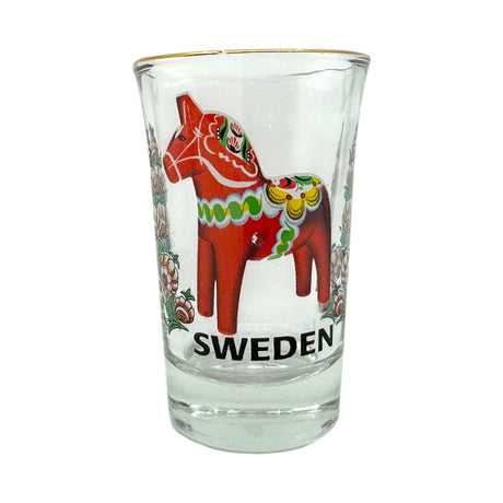 The Shot Glass: Sweden Red Dala Horse features a clear design with the iconic red Dala horse and vibrant patterns inspired by Scandinavian folk art, plus Sweden printed on it—a charming Nordic souvenir.