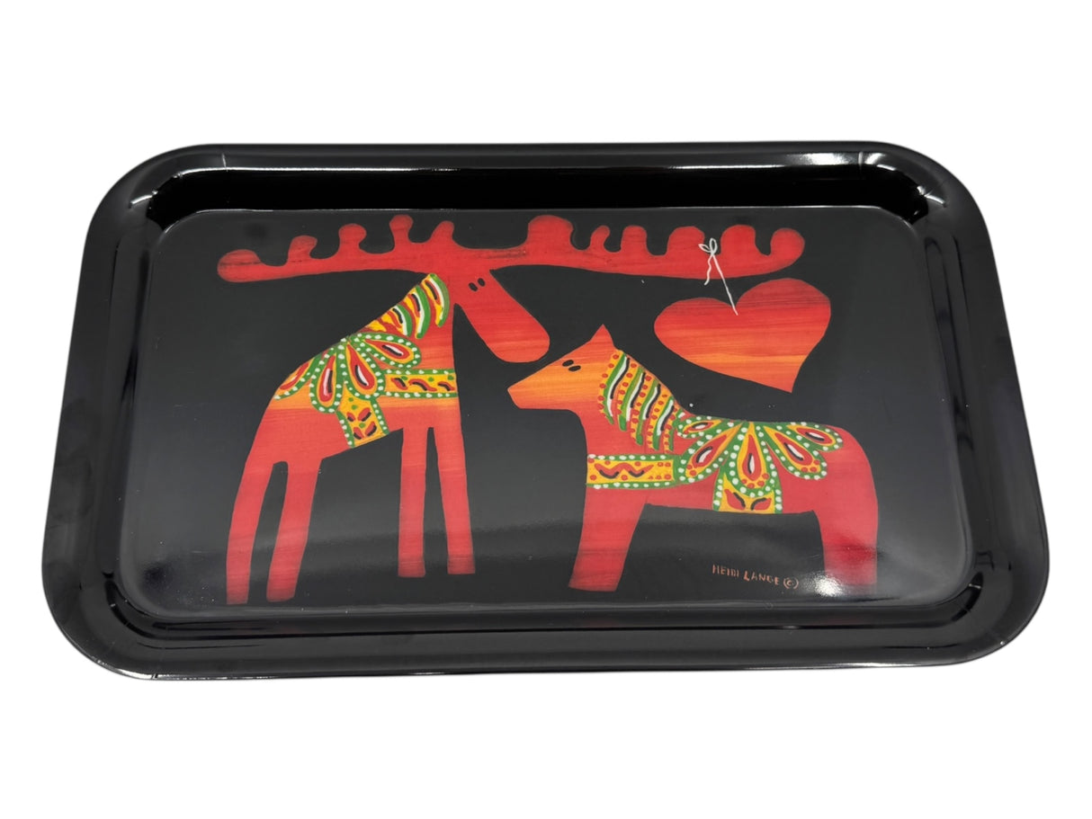 A black melamine tray (7.5" × 12.5") by Heidi Lange, featuring stylized Dala Moose and Dala Horse with a red heart between them, decorated in Swedish Kurbits patterns.