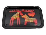 A black melamine tray (7.5" × 12.5") by Heidi Lange, featuring stylized Dala Moose and Dala Horse with a red heart between them, decorated in Swedish Kurbits patterns.