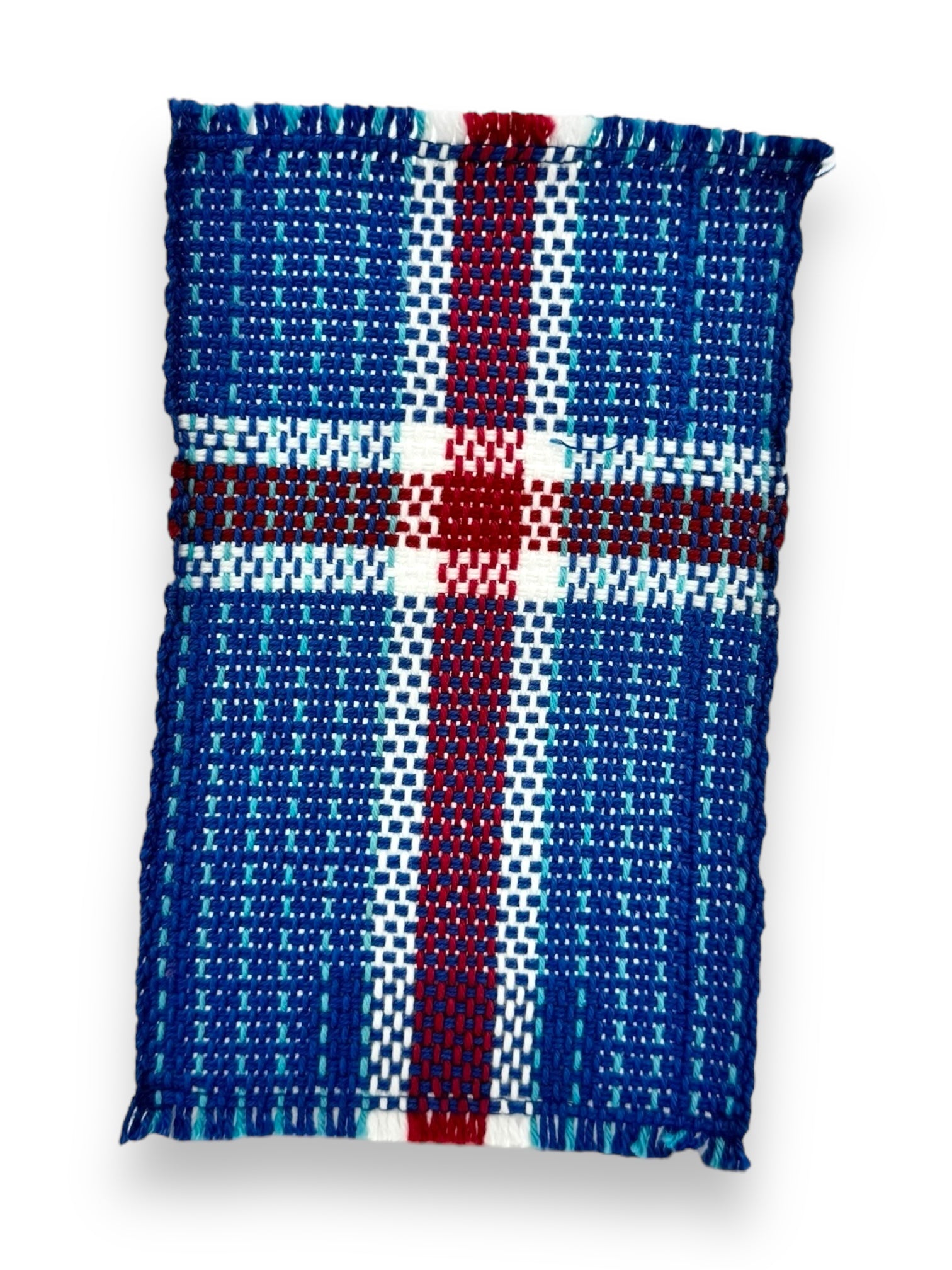 The coaster, named "Coaster: Iceland Flag (6.5"x4")," is intricately handwoven with a pattern that mirrors the blue, red, and white cross of the Icelandic flag.