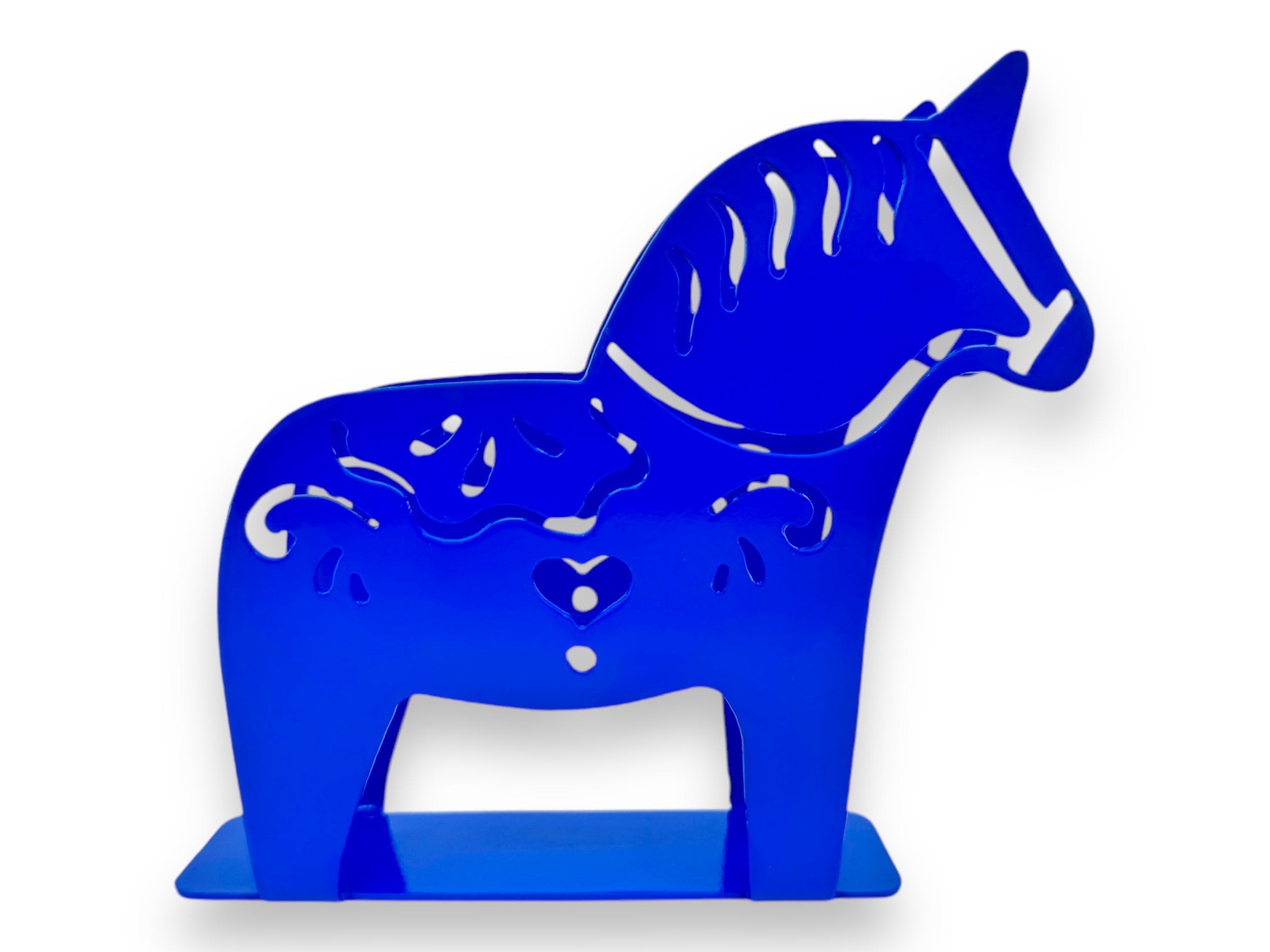 A laser cut metal napkin holder featuring a blue Dala horse silhouette with intricate kurbits cut-out patterns, standing upright.