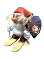 The NyForm - Nissen on Skis with Backpack is a charming collector's item crafted from wood, featuring a gnome wearing a red hat and white sweater as it skis. The attached tag showcases an illustration of another gnome along with text that embodies the essence of Norwegian design.