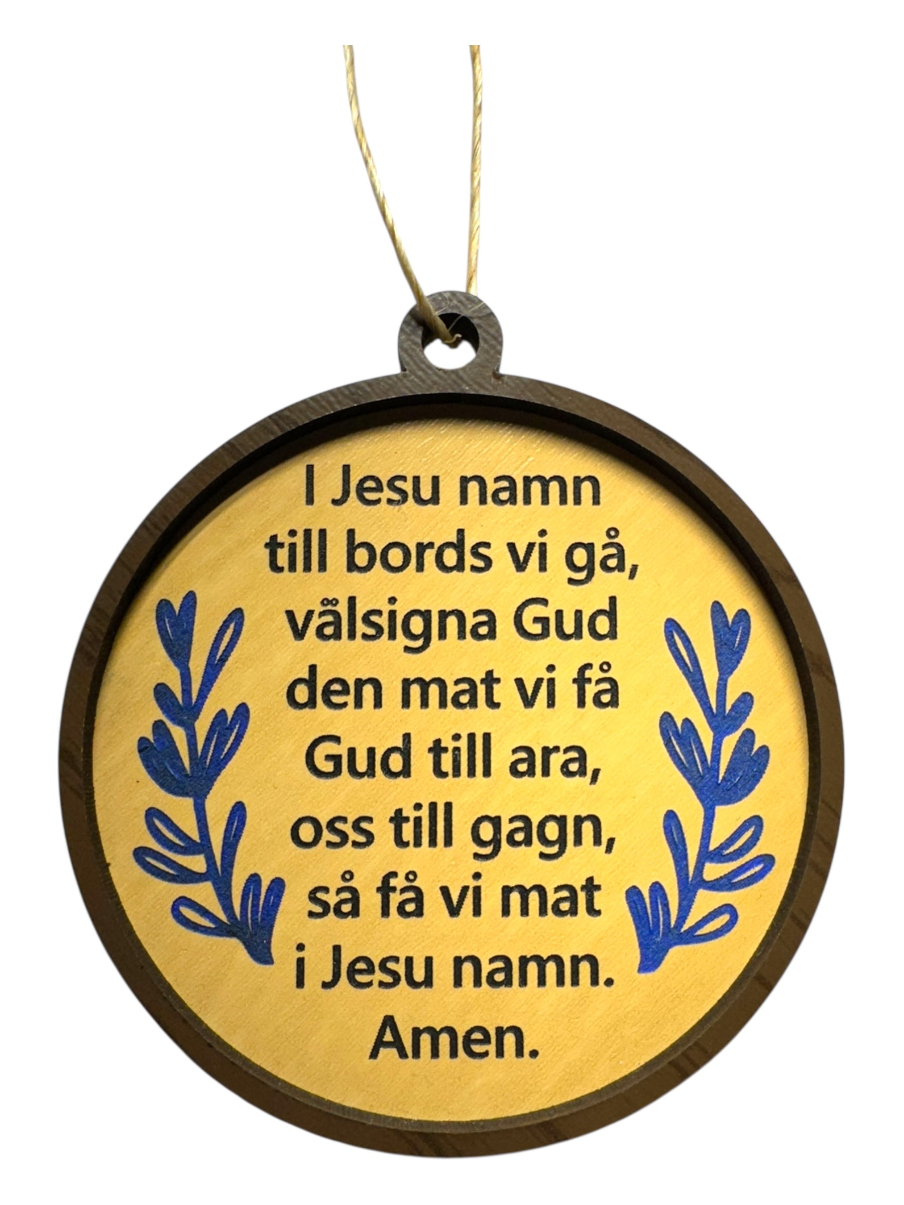 The Ornaments: Swedish Table Prayer is a round wooden ornament with blue leaf designs and Swedish text, featuring the Swedish Mealtime Prayer in black on a yellow background.