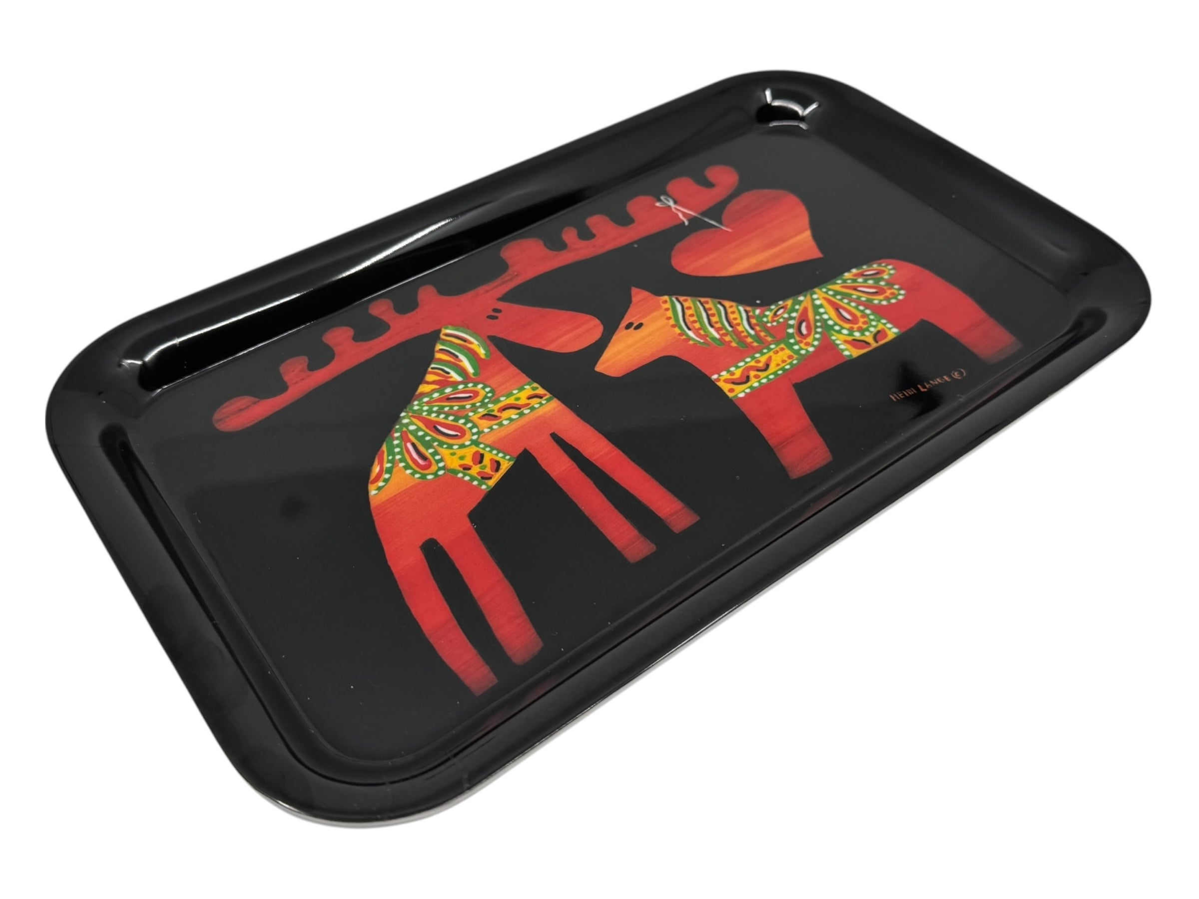 A black rectangular tray titled Tray: Dala Moose & Dala Horse with Heart by Heidi Lange, featuring two stylized red figures with yellow and green Swedish Kurbits patterns and a large red heart between them.