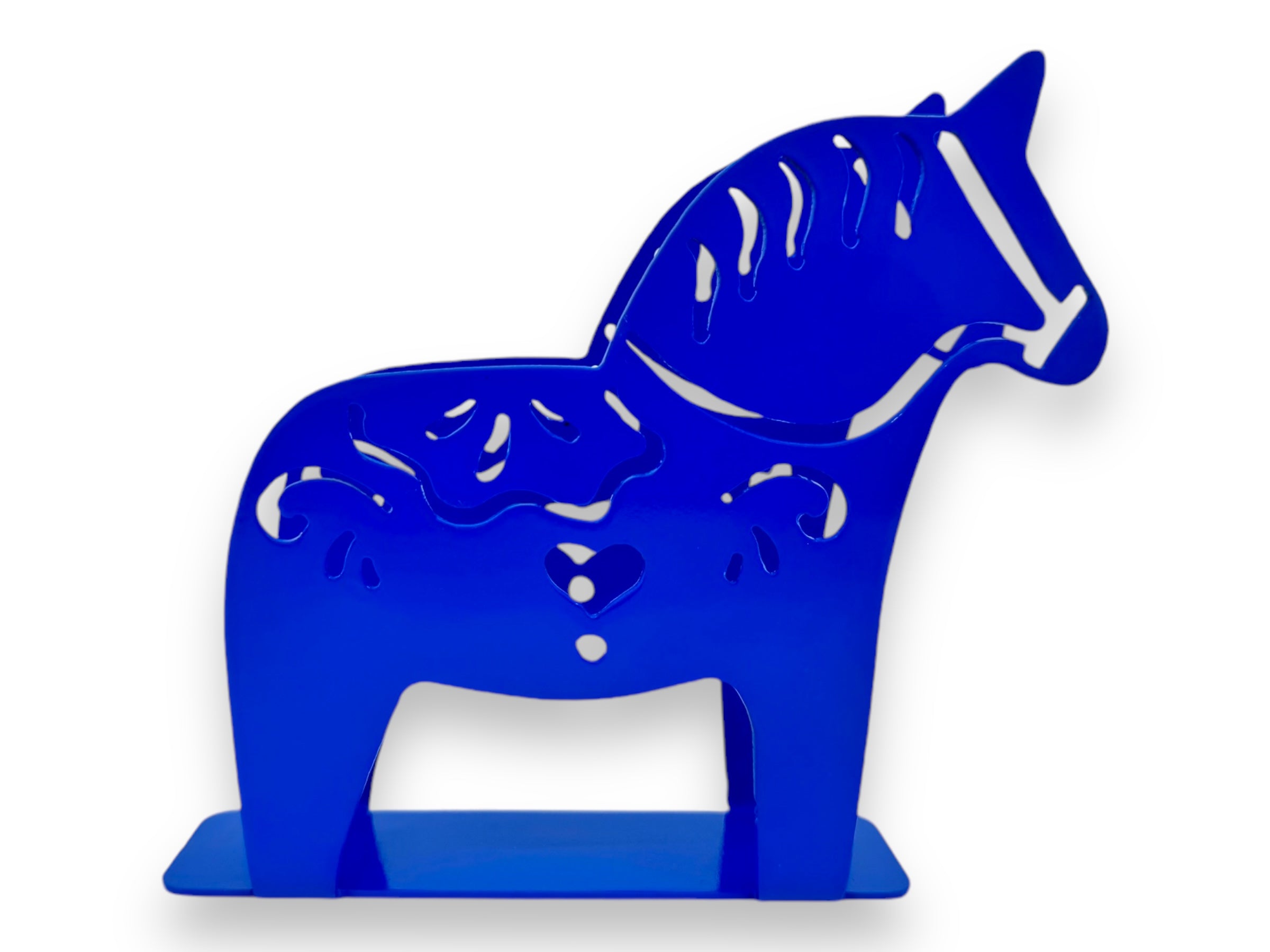 The product is a blue silhouette sculpture of a horse with kurbits patterns, expertly laser-cut and designed to stand upright on a rectangular base, known as the "Napkin Holder: Laser Cut Metal Dala Horse.