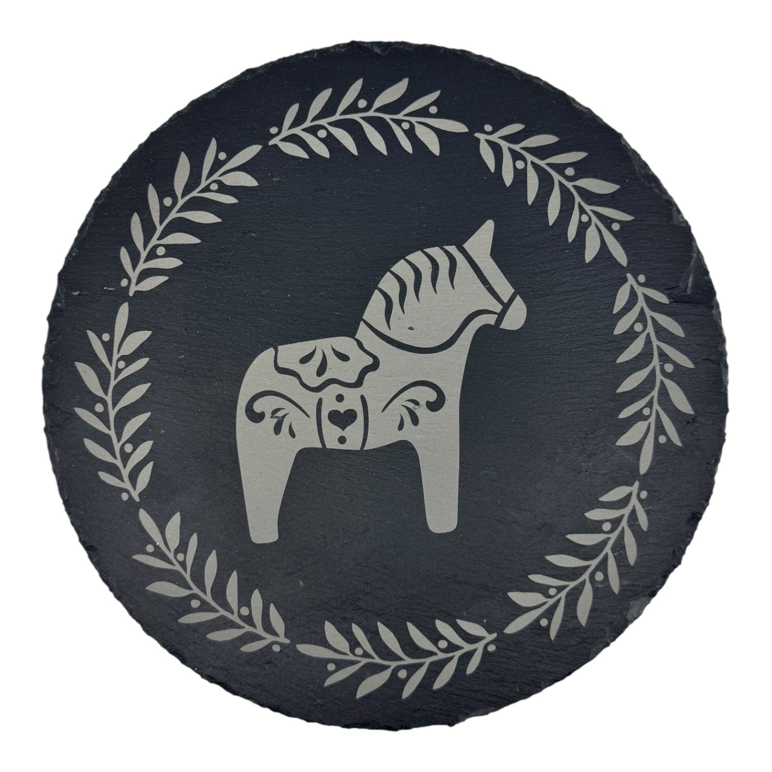 The Trivet: Swedish Dala Horse on 9.75 Slate Trivet features a black circular slate with a white, stylized Swedish Dala Horse in the center, encircled by a classic Scandinavian leaf wreath border.