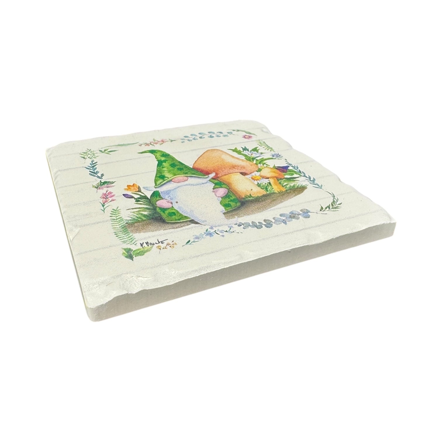 The Coaster: Spring Gnomes Tumbled Tile Coaster (Yellow, Blue, Green or Pink) is a ceramic tile with a rustic look featuring gnomes, mushrooms, and flowers bordered by a floral wreath—ideal for spring decor or absorbent stone coasters.