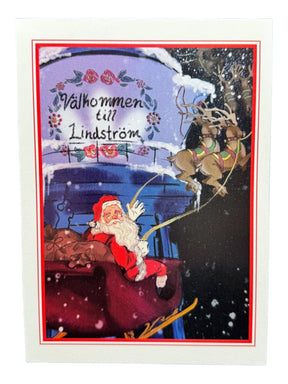 Card: Santa in Lindström – Holiday Greeting Card (5×7 in) features Santa Claus flying over snowy Lindström, passing the Coffee Pot Water Tower and a Välkommen till Lindström sign—perfect for celebrating Swedish heritage.