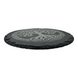 The 9.75 slate trivet features a carved Tree of Life design inspired by Norse mythology, showcased on round black slate.