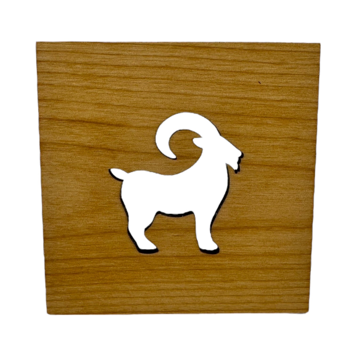 The Coaster: Swedish Goat 4x4 Square Alder Coaster showcases a Scandinavian-inspired white silhouette of a goat with curved horns at its center, crafted from alder wood.