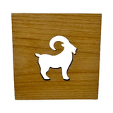 The Coaster: Swedish Goat 4x4 Square Alder Coaster showcases a Scandinavian-inspired white silhouette of a goat with curved horns at its center, crafted from alder wood.