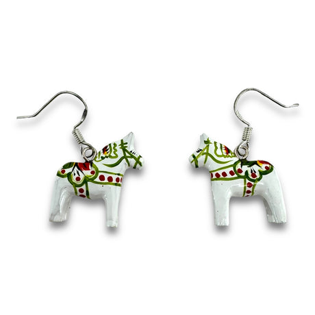 A set of expertly crafted earrings designed with white Dala horse-shaped charms adorned with green and red patterns, skillfully attached to silver hooks.