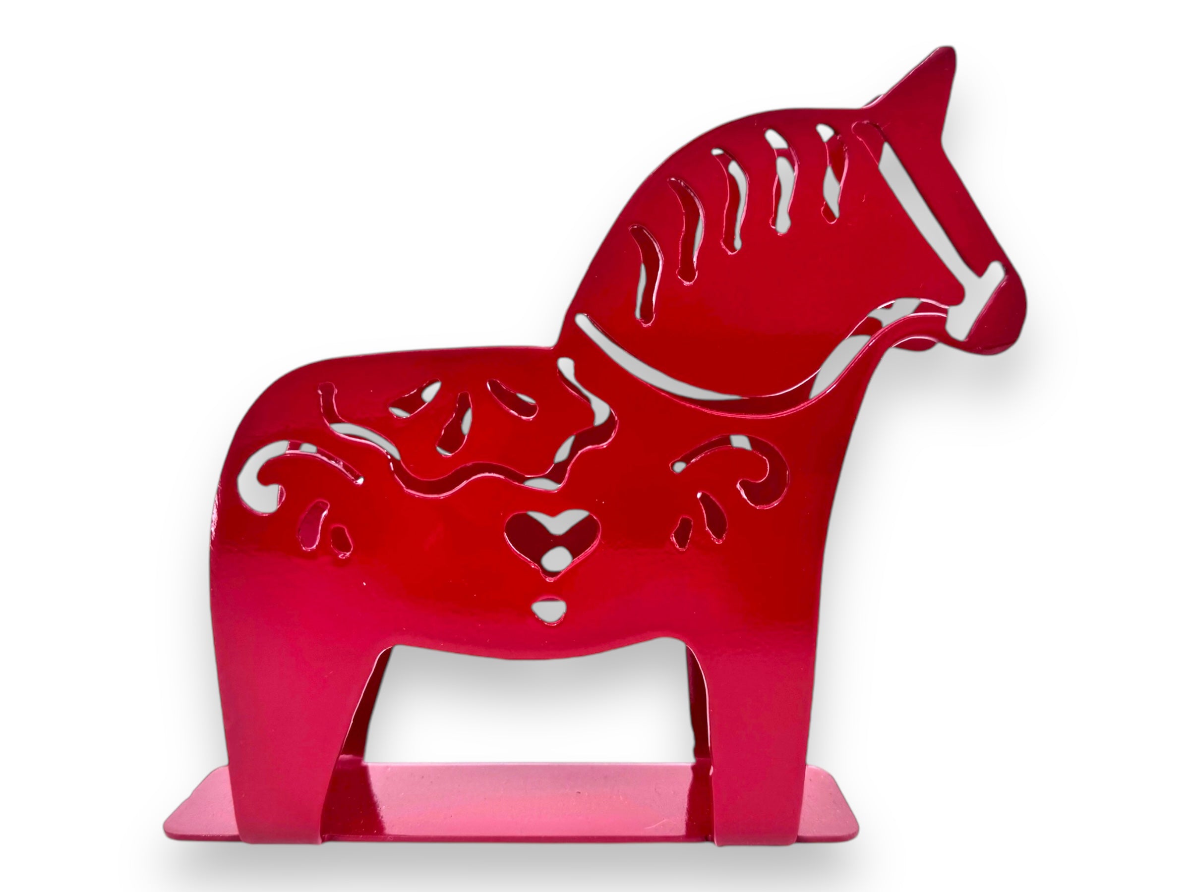 This Napkin Holder: Laser Cut Metal Dala Horse is a red, horse-shaped decorative piece featuring intricate kurbits-inspired cut-out patterns and stands confidently on a flat base, making it perfect as a unique napkin holder.