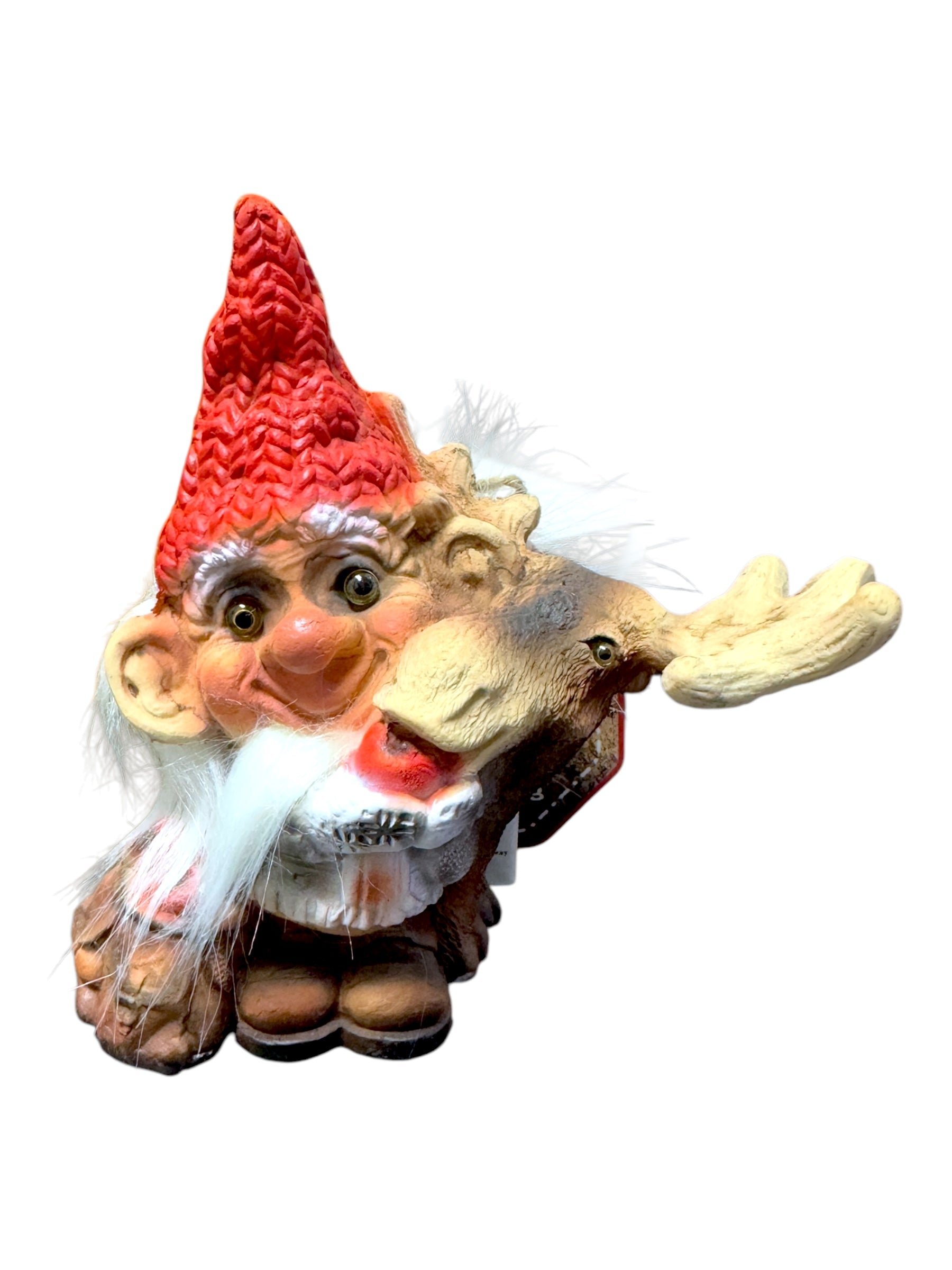 The Troll: NyForm - Nissen Feeding Moose figurine is a collector's item that artfully combines a bearded gnome with a moose head, adorned with a red hat and showcasing detailed facial features in true Norwegian design. It is beautifully isolated on a white background.