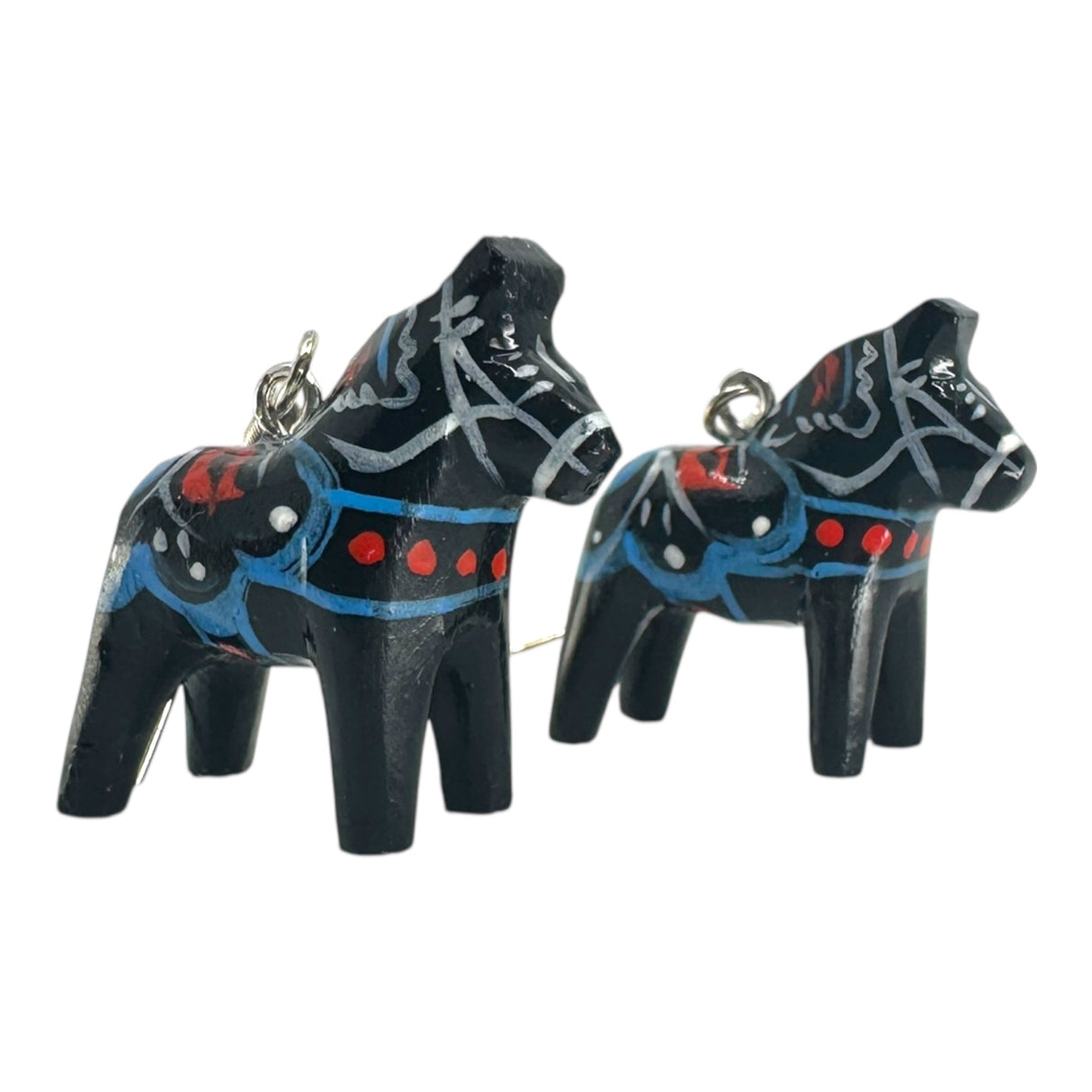 Two black Dala Horse earrings (2cm/0.75 high) inspired by handcrafted Swedish folk art, featuring blue, red, and white painted patterns and a metal loop—perfect for adding a touch of tradition to your jewelry collection.