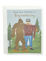 Celebrate with the Hope Your Birthday is Legendary with Bigfoot & Paul Bunyan Birthday Card, featuring Paul Bunyan in plaid alongside Bigfoot and pine trees. A fun greeting card for anyone who loves a tall tale!.