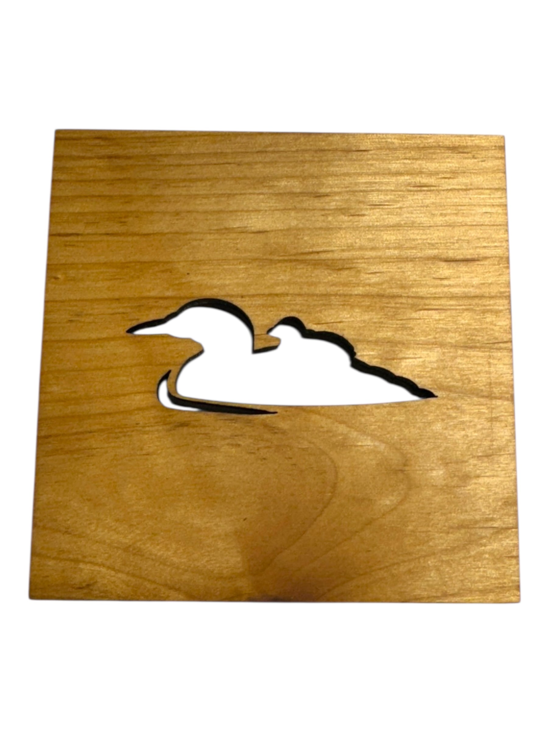 A 4x4 square alder wood coaster featuring a laser-cut silhouette of a loon.