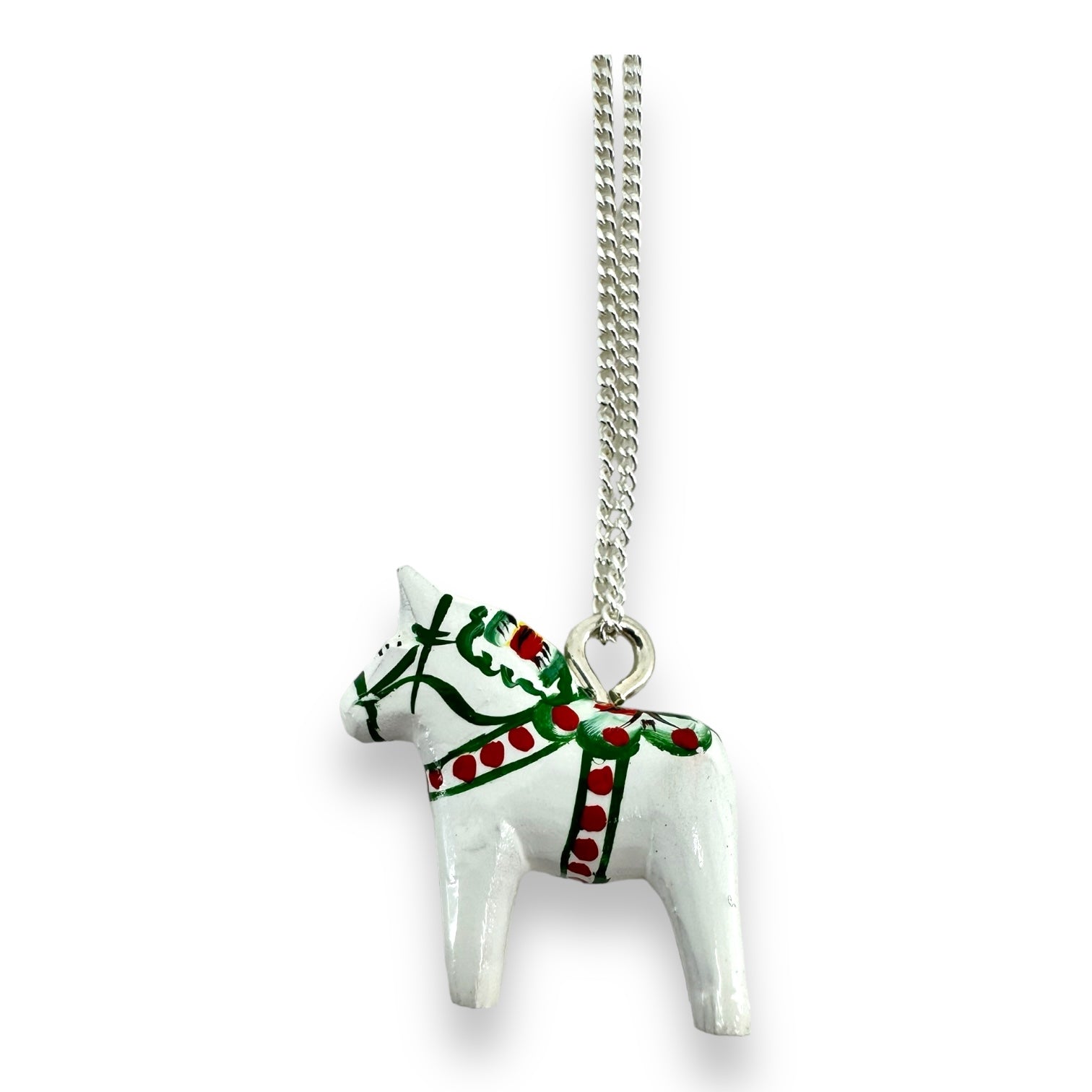 Introducing our Dala Horse Necklace White 3cm: a beautifully hand-crafted piece featuring a pendant painted in white and red that captures the charm of a Swedish Dala Horse, elegantly suspended on a silver chain.