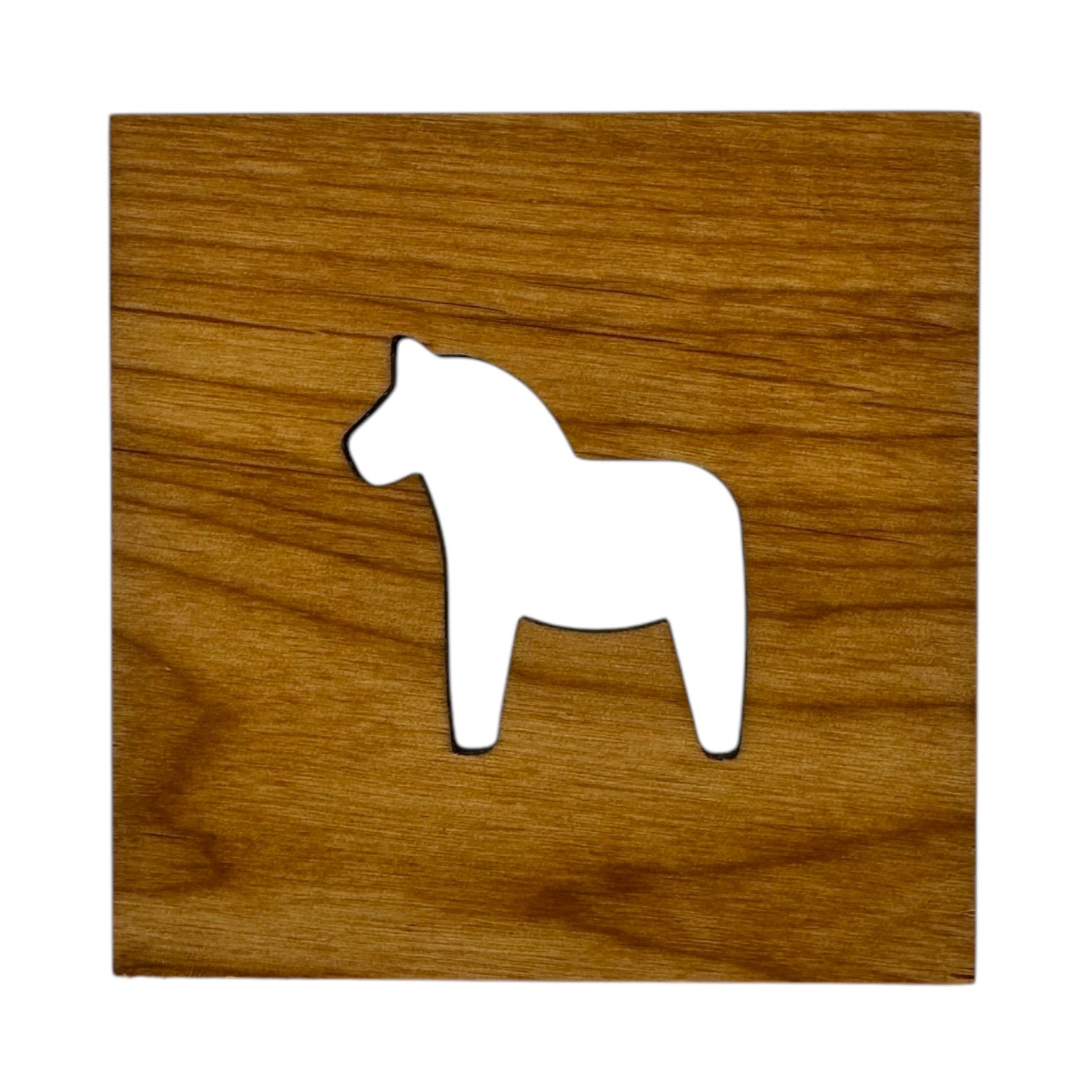 The Coaster: Swedish Dala Horse 4x4 Square Alder Coaster is made from alder wood and features a white horse-shaped cutout inspired by Scandinavian design.