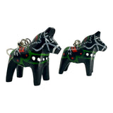 A pair of small black Dala Horse earrings (2cm/0.75 high), handcrafted in Swedish folk art style with painted green, white, and red details.