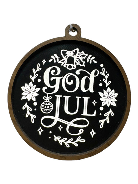 The Ornaments: God Jul Black with White Lettering & Trim brings Swedish Christmas charm to your décor, featuring white text and floral designs—perfect as a festive Merry Christmas ornament.