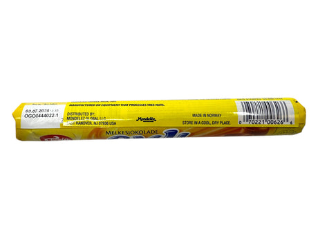 A yellow-wrapped bar labeled Freia Smil Milk Chocolate Caramel Roll (78g) displays distributor and manufacturing info, barcode, and storage instructions.