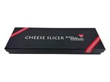 Rectangular black box labeled Cheese Slicer: Smooth Norwegian Cheese Slicer with Images of a Viking Ship & Moose on Pewter Handle, Nordic heritage red and white stripes, website on lid, cheese slicer inside.