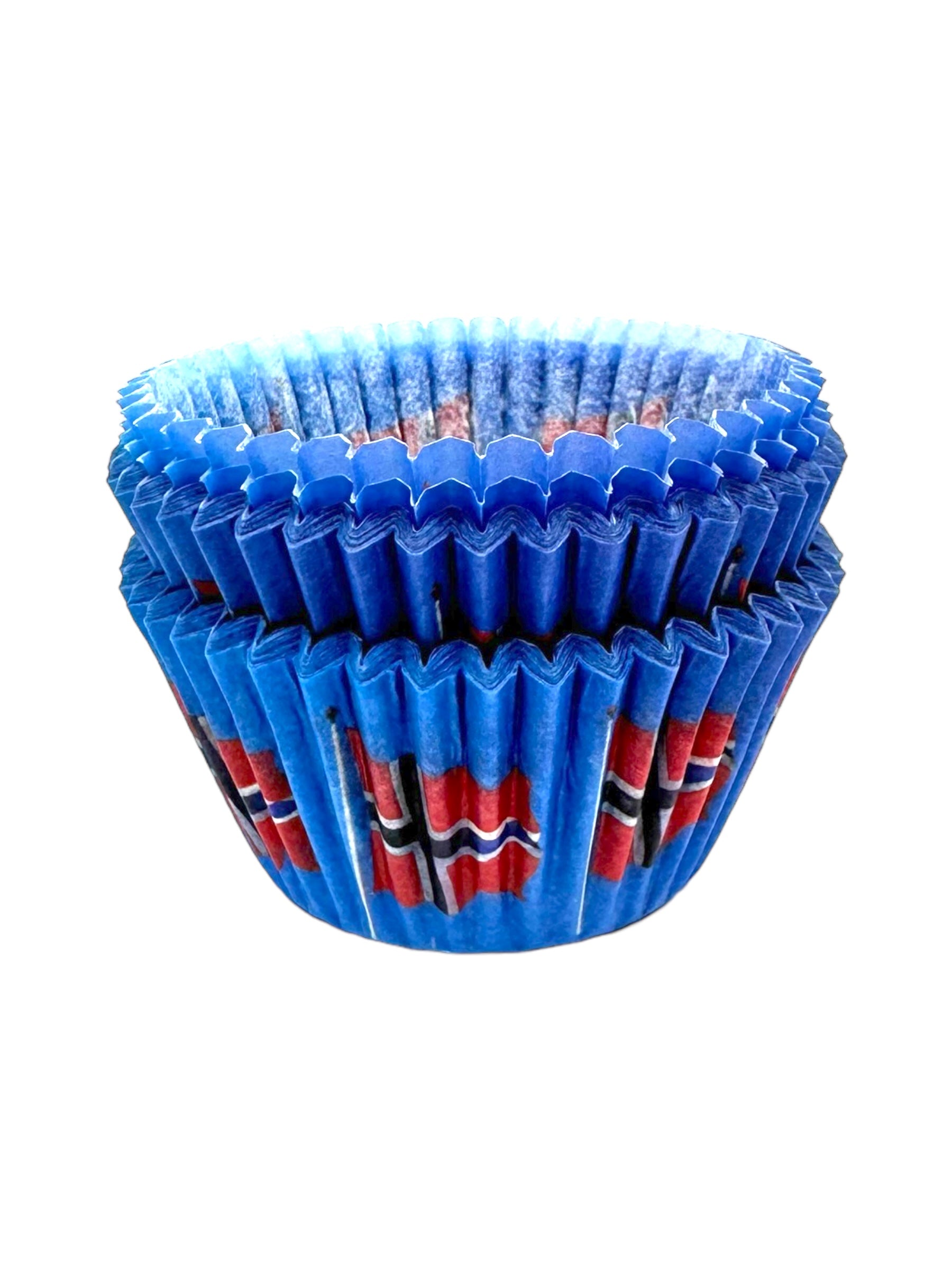 A set of blue cupcake liners decorated with red, white, and black motifs inspired by the Norwegian flag.