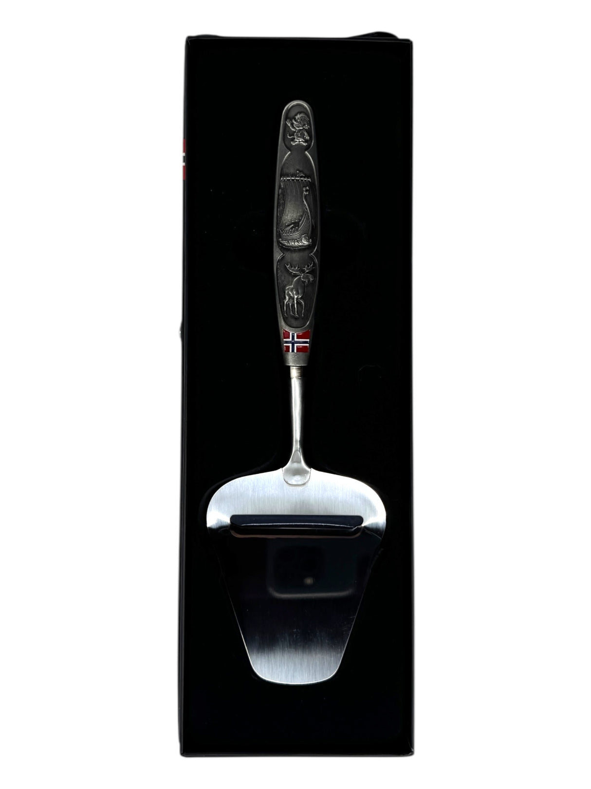 A smooth Norwegian cheese slicer with a pewter handle featuring images of a Viking ship and moose, reflecting Nordic heritage, beautifully presented in a black box.