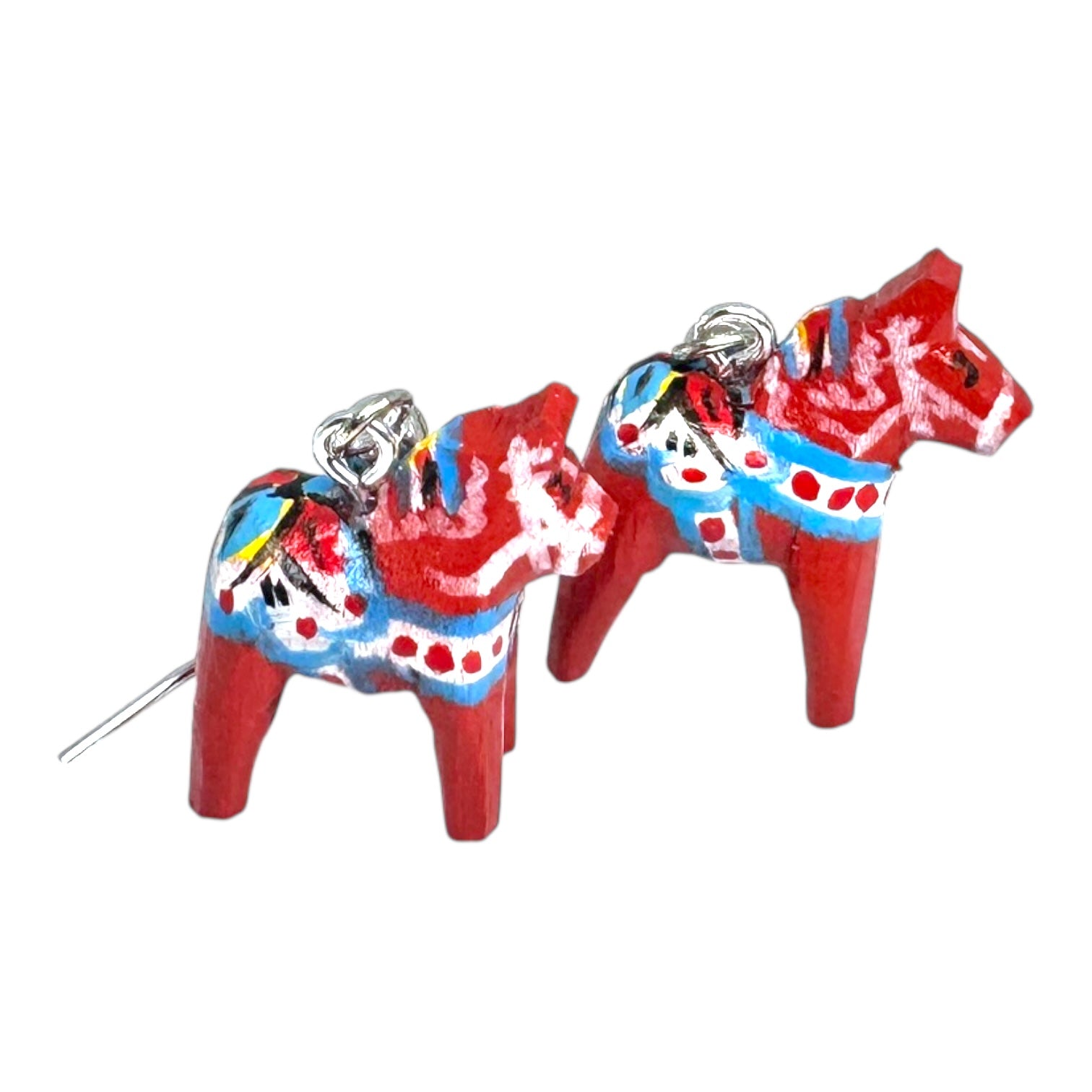 These Dala Horse Red Earrings (2cm/0.75 high) are handcrafted Swedish folk art jewelry, featuring painted wooden horses with blue, white, and yellow patterns and silver hooks.