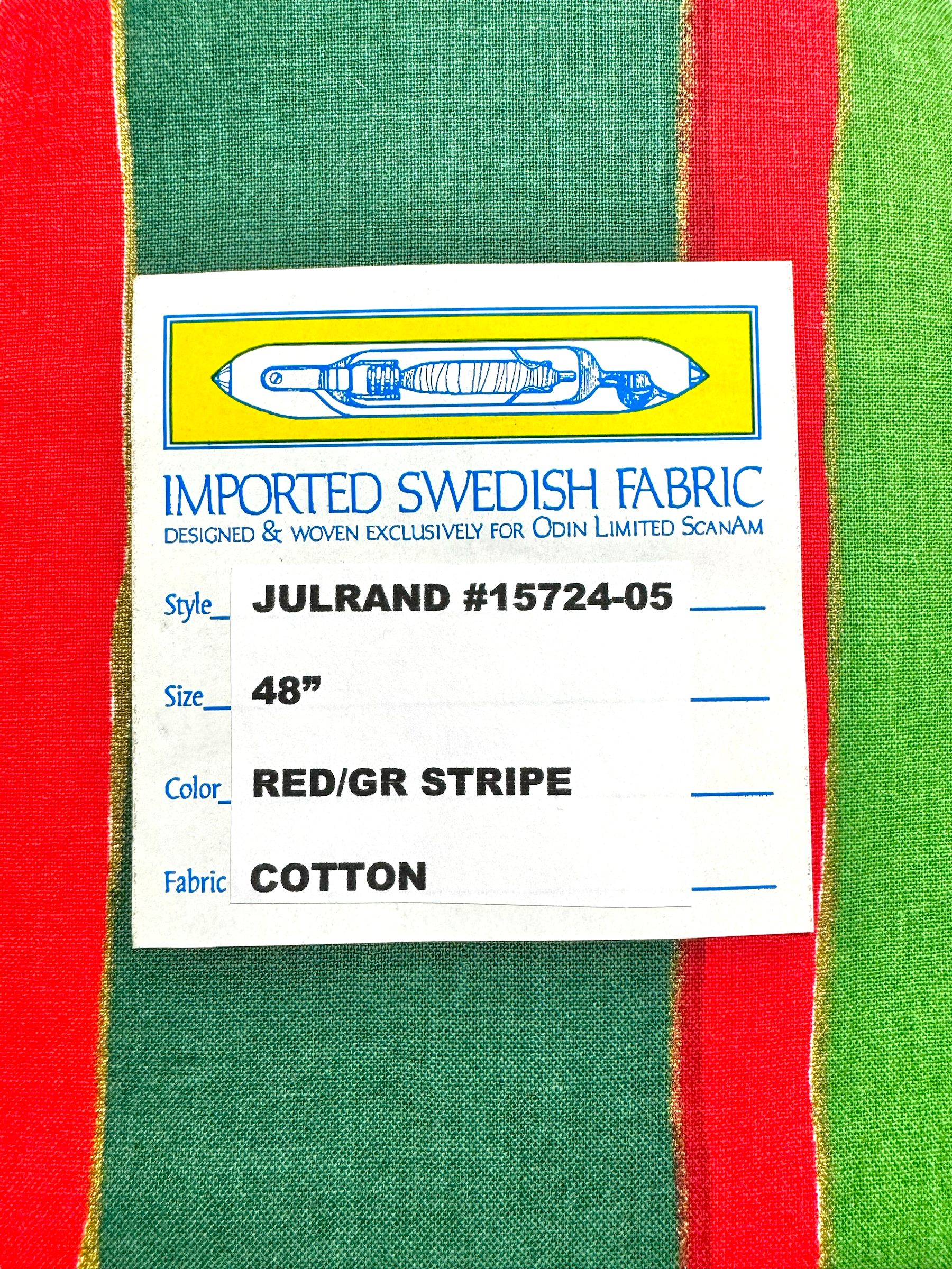 Label on luxurious fabric: Crafted from Imported Swedish Fabric, Style: JULRAND #15724-05, Size: 48, Color: Red/Gr Stripe. This Cotton Table Runner design, known as the Julrand Holiday Runner, showcases a vivid background adorned with stripes in red, green, and yellow.