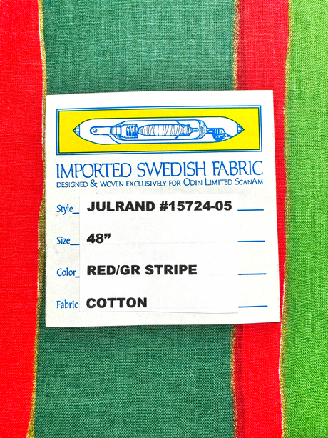 Label on luxurious fabric: Crafted from Imported Swedish Fabric, Style: JULRAND #15724-05, Size: 48, Color: Red/Gr Stripe. This Cotton Table Runner design, known as the Julrand Holiday Runner, showcases a vivid background adorned with stripes in red, green, and yellow.