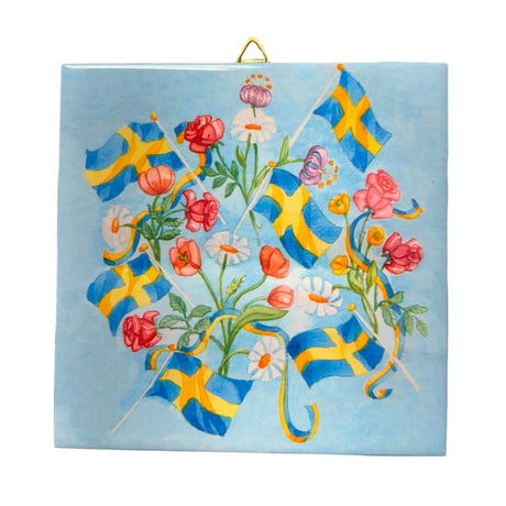 The Tile: Swedish Flags & Flowers Ceramic Tile – 6" features Swedish flags and colorful flowers on a light blue background, with cork backing and a brass hanger—ideal for Scandinavian-inspired floral decor.