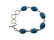 A sterling silver bracelet with seven oval Swedish blue stones set in individual links on a chain is elegantly displayed against a black background.
