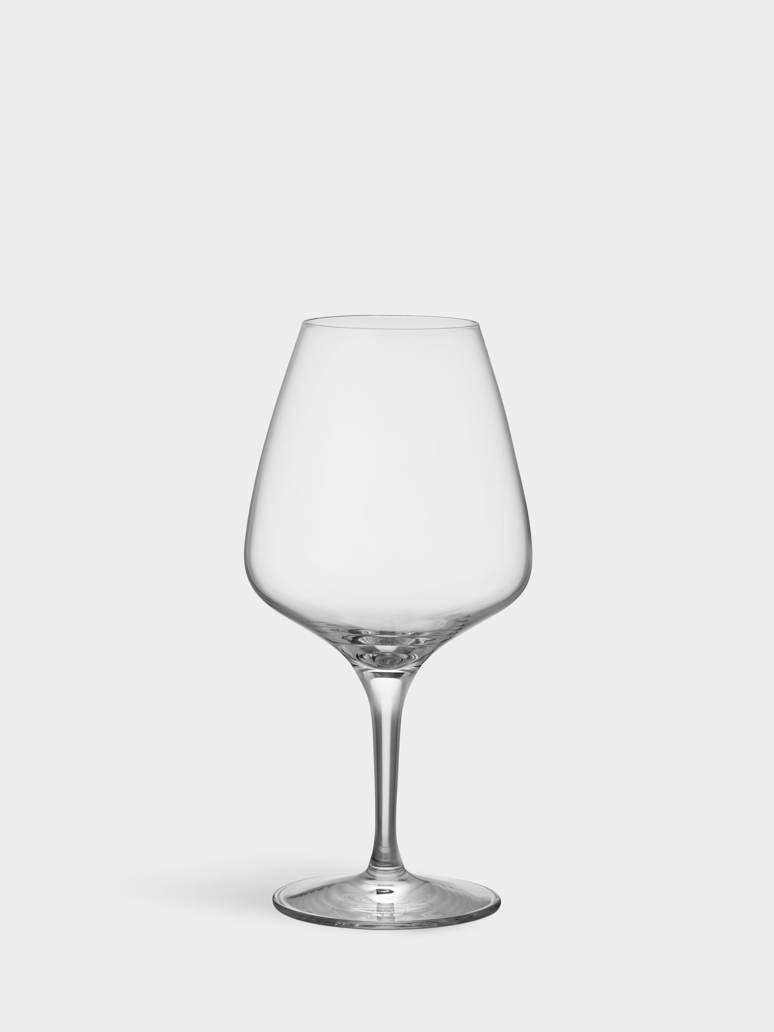 The Orrefors Pulse Wine Glass 15.5oz (4-Pack) features a clear, empty glass with a wide bowl and slender stem, highlighting its elegant Scandinavian design on a plain white background.