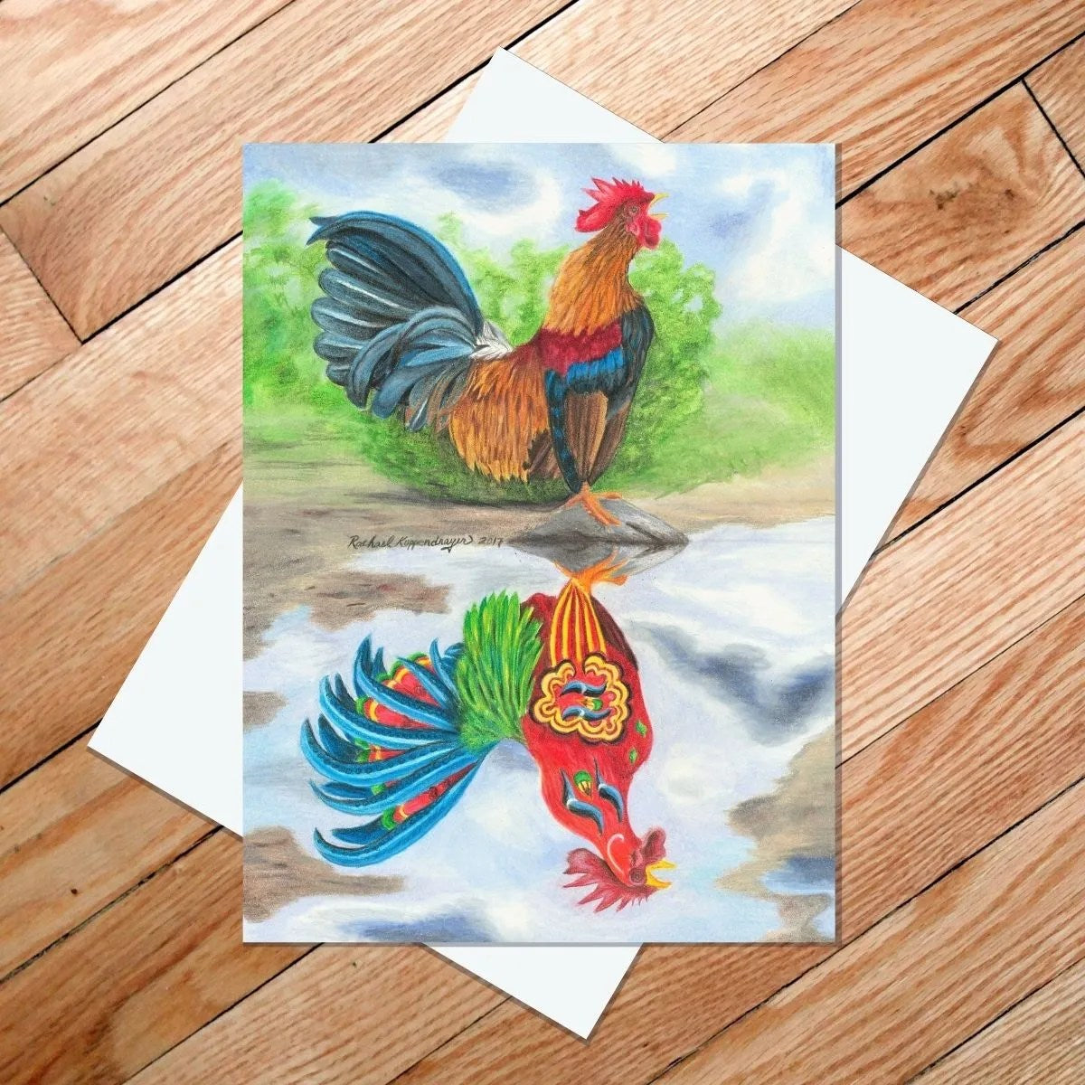 A vibrant color pencil drawing of a Dala rooster is beautifully featured on the "Dala Rooster Reflection" 5x7 card, capturing its colorful reflection on a wooden floor.