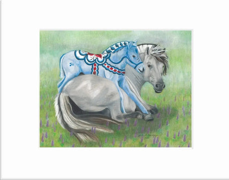 Two horses rest on the grass, with one adorned in a design reminiscent of the "Fjord Foal Dala Horse" 25x21 Framed, capturing the essence of Norwegian folklore.