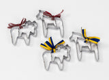 The Swedish Dala Horse Cookie Cutters (2-Pack) set includes four stainless steel animal-shaped cutters with colorful ribbons. Two come with red ribbons, and two are decorated in blue and yellow, all displayed beautifully on a white background.
