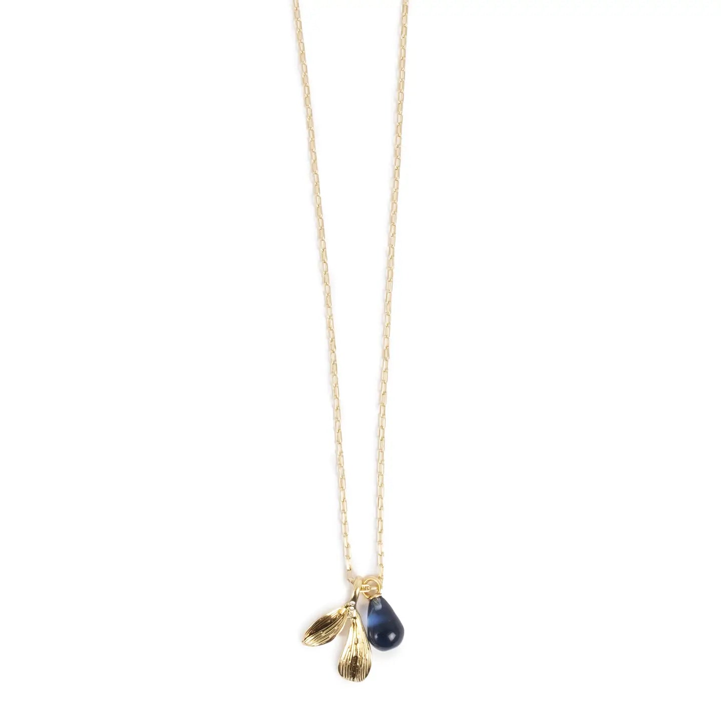 The Necklace: Botanic Hand Cut Glass Blue & Gold Necklace has gold plating with a delicate chain featuring three pendants - two gold leaf shapes and a dark blue hand-cut glass teardrop.