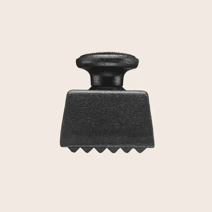 The Skeppshult Meat Tenderizer features a black cast-iron design with a flat, grooved head, ergonomic styling, and a short handle set against a light background.