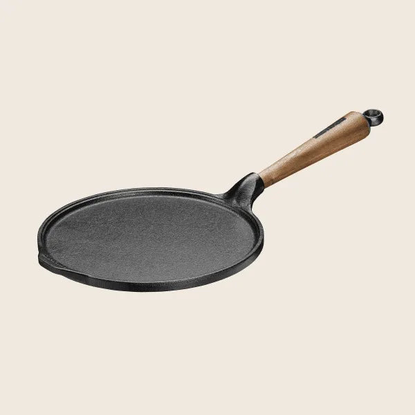 Skeppshult 9.25 pancake pan with a walnut handle displayed on a light background.