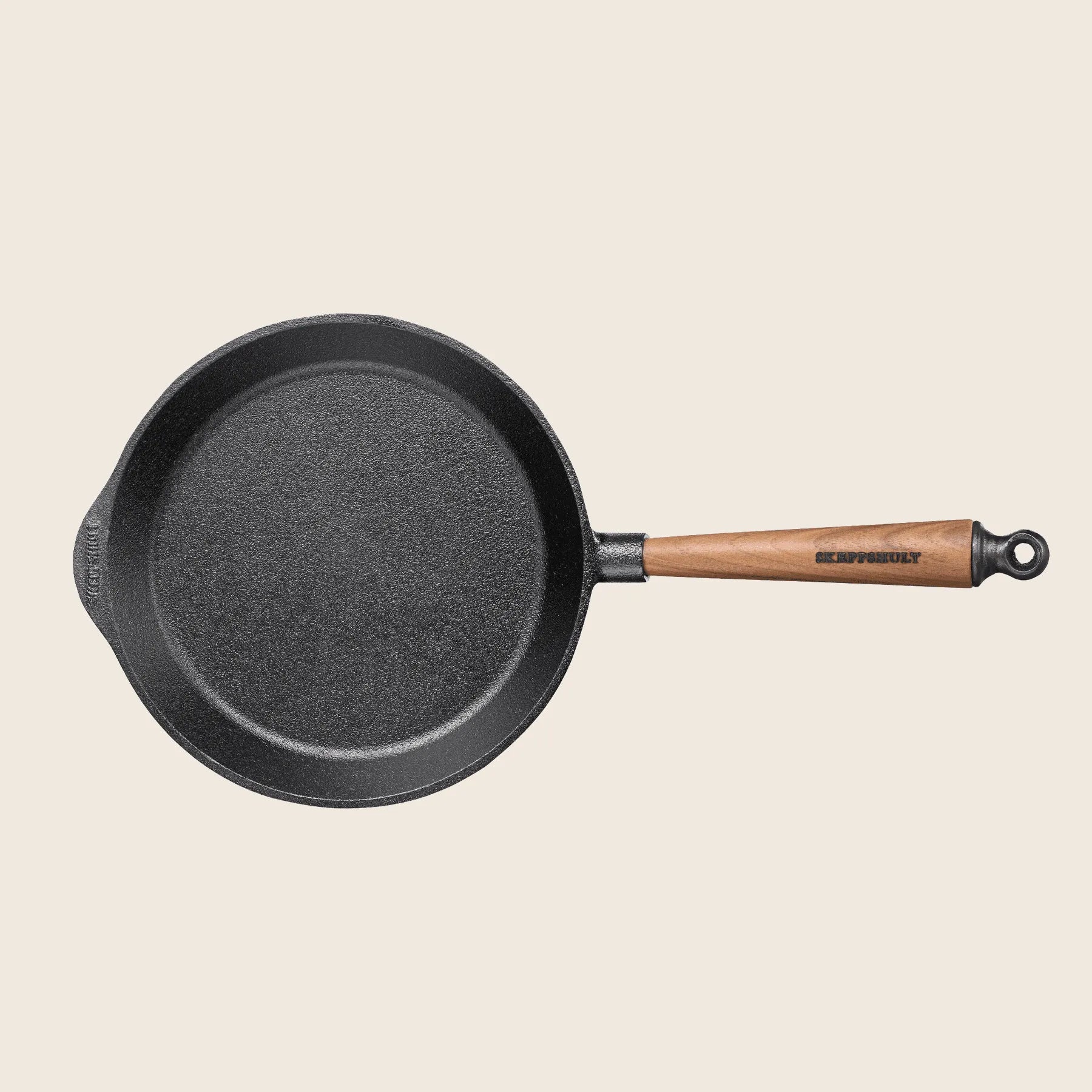 Skeppshults 9.5 skillet with a walnut handle offers excellent heat conduction and is shown on a light background.