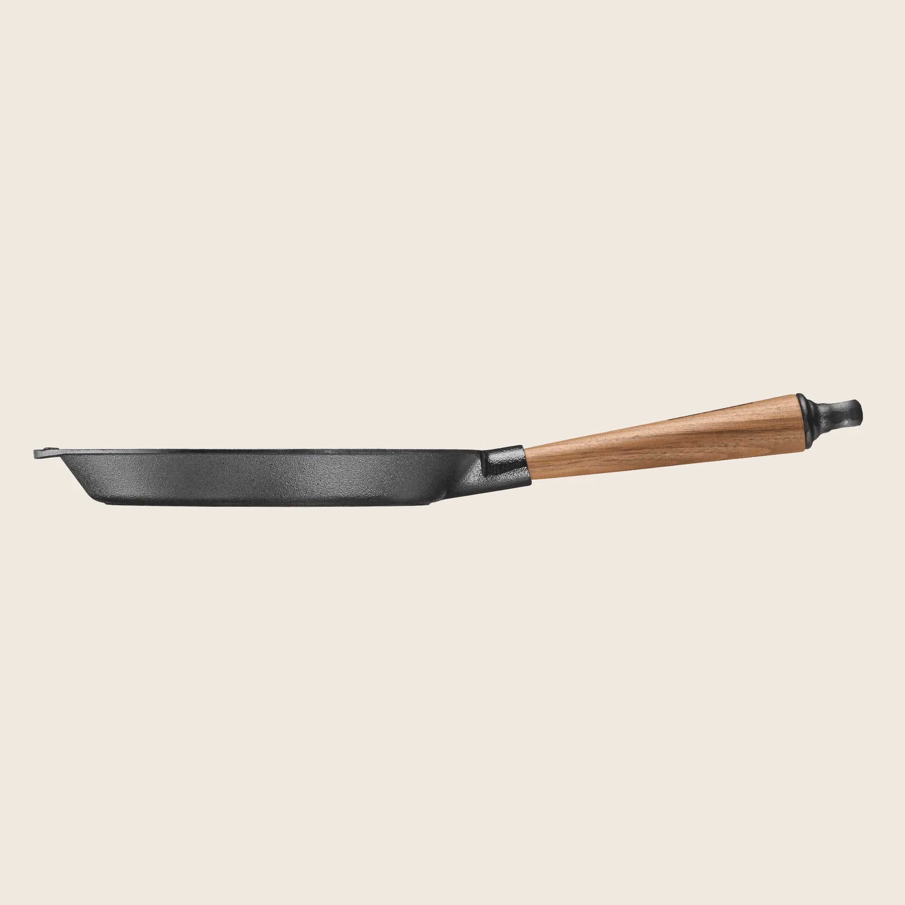 The side view shows a Skeppshult Skillet With Walnut Handle (9.5/24 cm) on a plain background, renowned for excellent heat conduction.